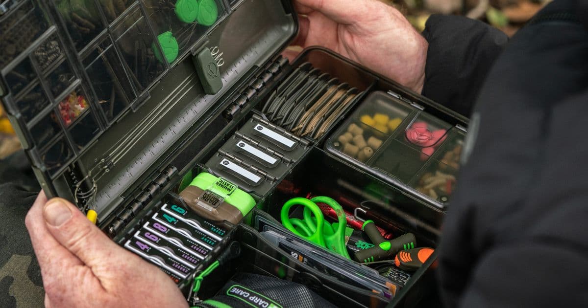 A selection of tied carp rigs laid out on a rig board