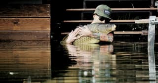 An angler playing a carp at dawn on a Romanian carp lake