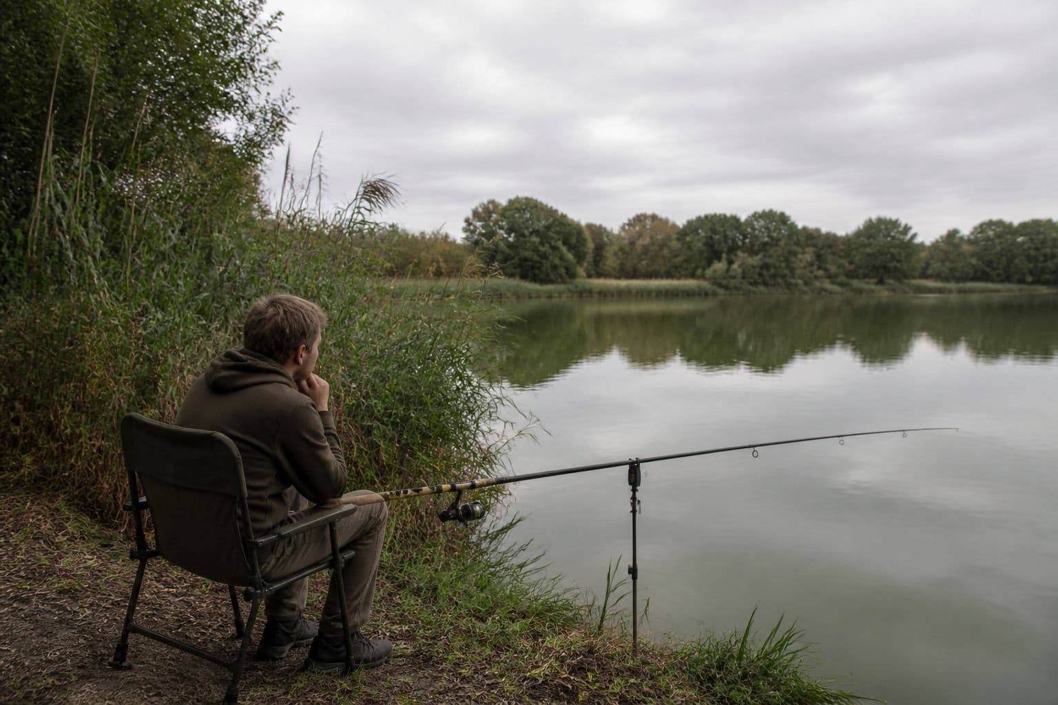 A single rod fished down the edge along rushes, the angler sat well back from the water